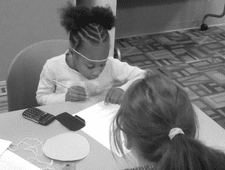 Kids Count STEM Club Girl working on math problems